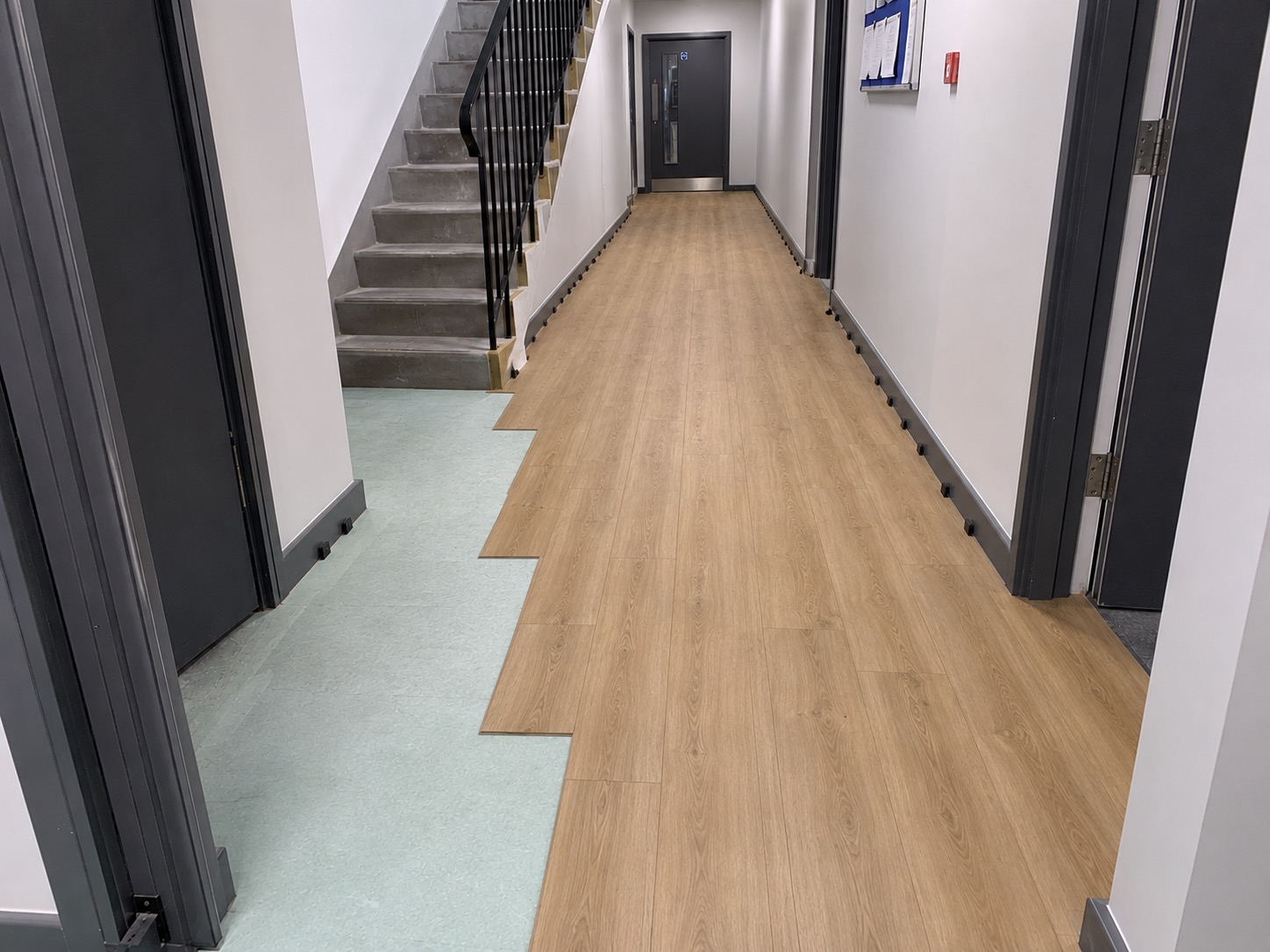 New wood-effect flooring laid in a communal hallway
